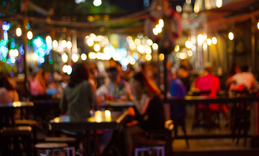A blur image of people having fun on outdoor bar