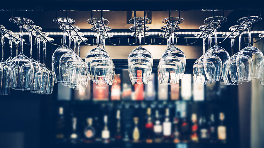 View of wine glasses hanging in a rack