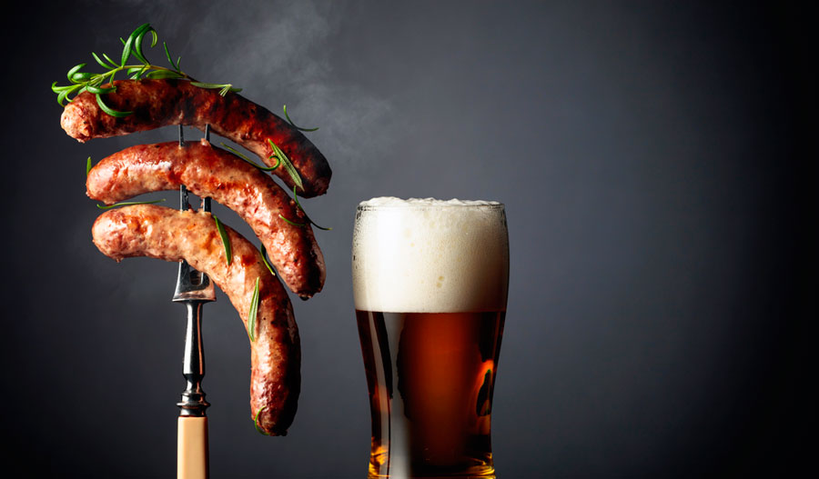 View of a glass of beer and sausages