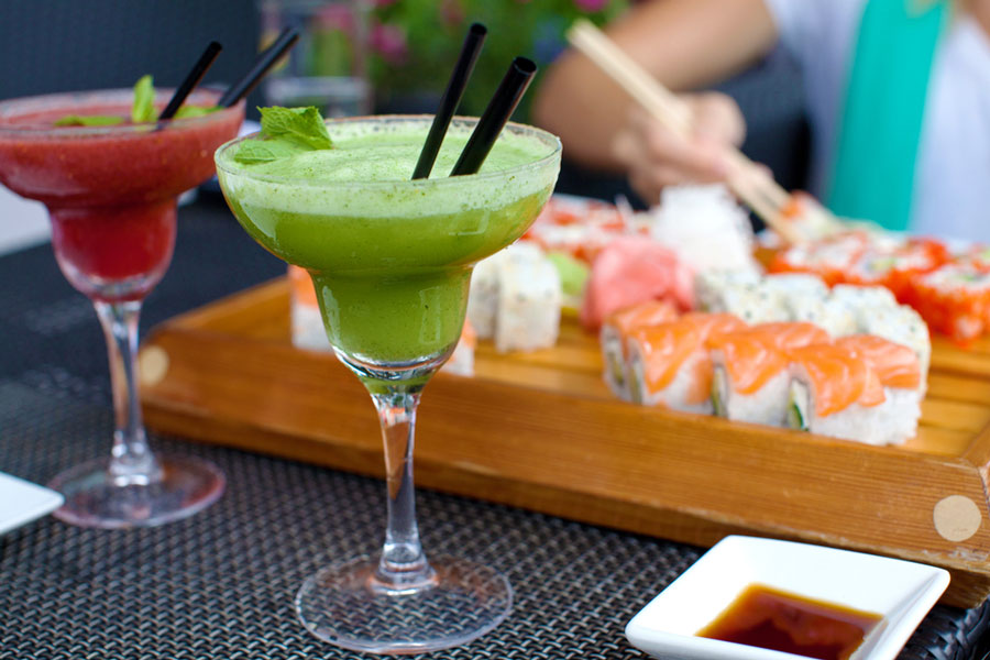 View of sushi and cocktails on a table
