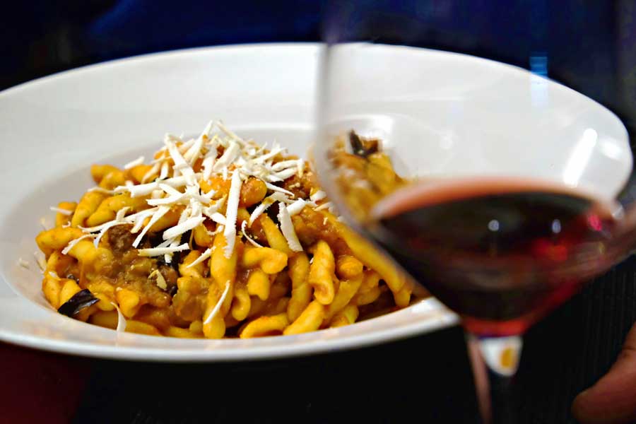 View of a glass of wine and a pasta