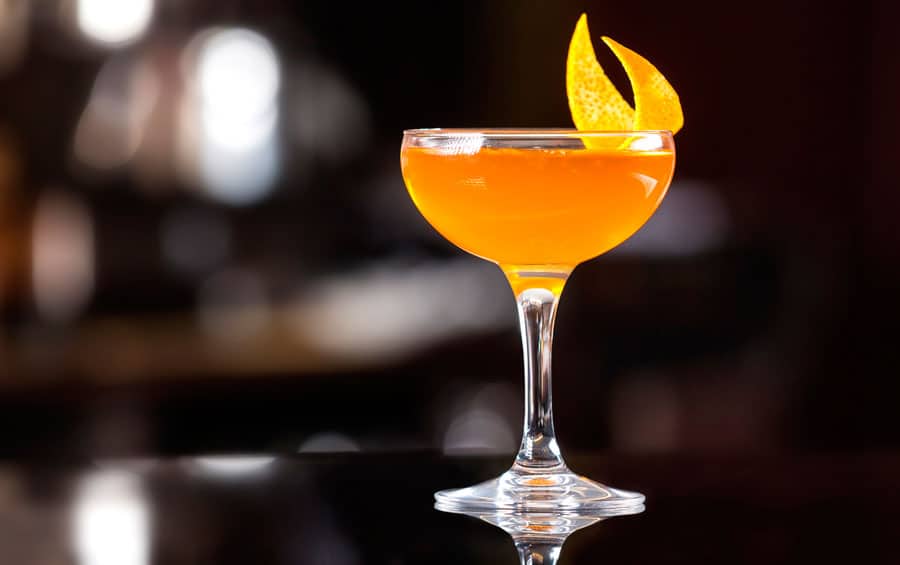 View of a cocktail with an orange peel
