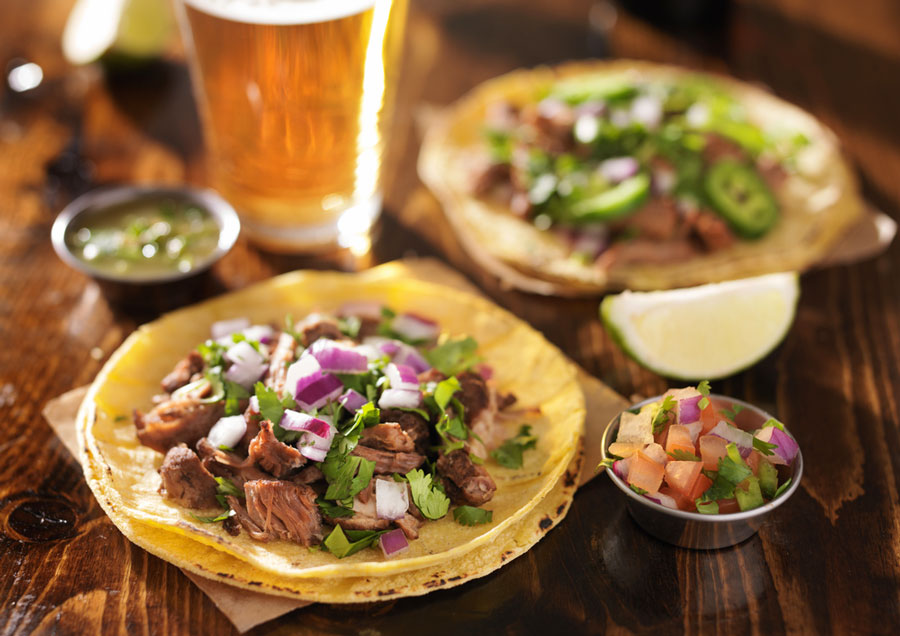 View of a tacos and a beer on a table