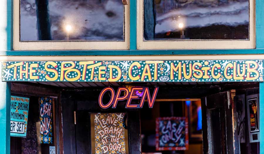 View of The Spotted Cat Music Club open sign on the entrance