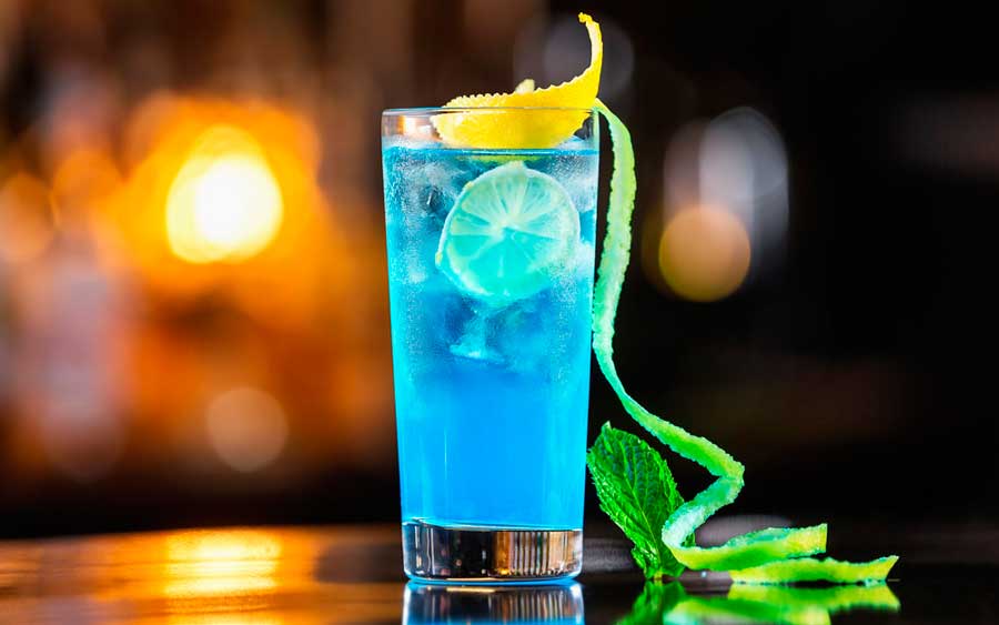 View of the blue cocktail with lemon peel on it