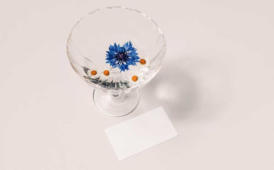 A glass of cocktail and flowers on it