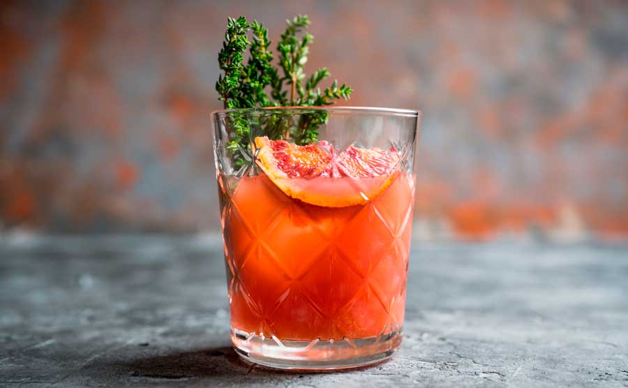 View of a glass of cocktail with blood orange on it